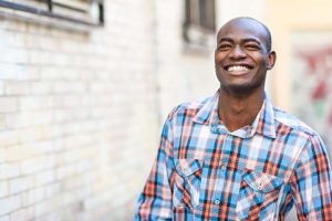 man smiling outside addiction recovery center location