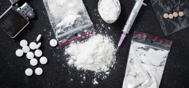 drugs in pill and powder form with needle