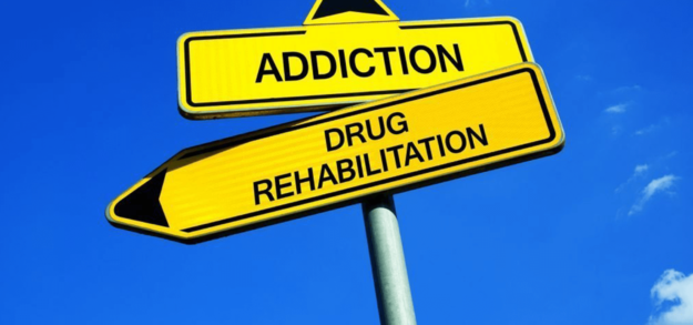 sign reading Addiction above side reading Drug Rehabilitation