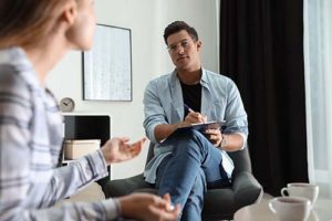 therapist listening to patient in substance abuse treatment