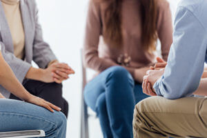 a group of people discussing their time during cognitive behavioral therapy program
