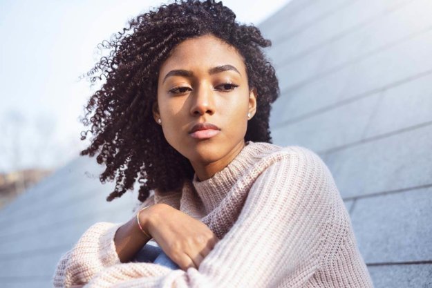 a woman sitting on her roof thinking about childhood trauma and addiction