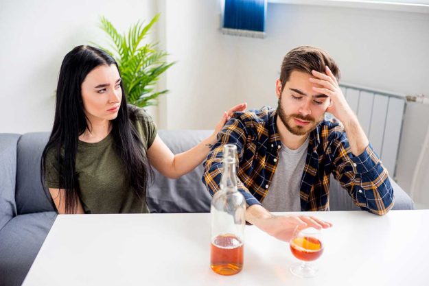 a woman trying to comfort a loved one living with an alcoholic