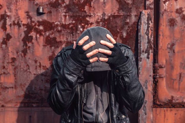 Homeless drug addict having abstinence crisis individual in hoodie showing signs of relapse