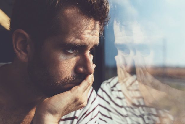 The Signs of a Heroin Overdose male looking outside window